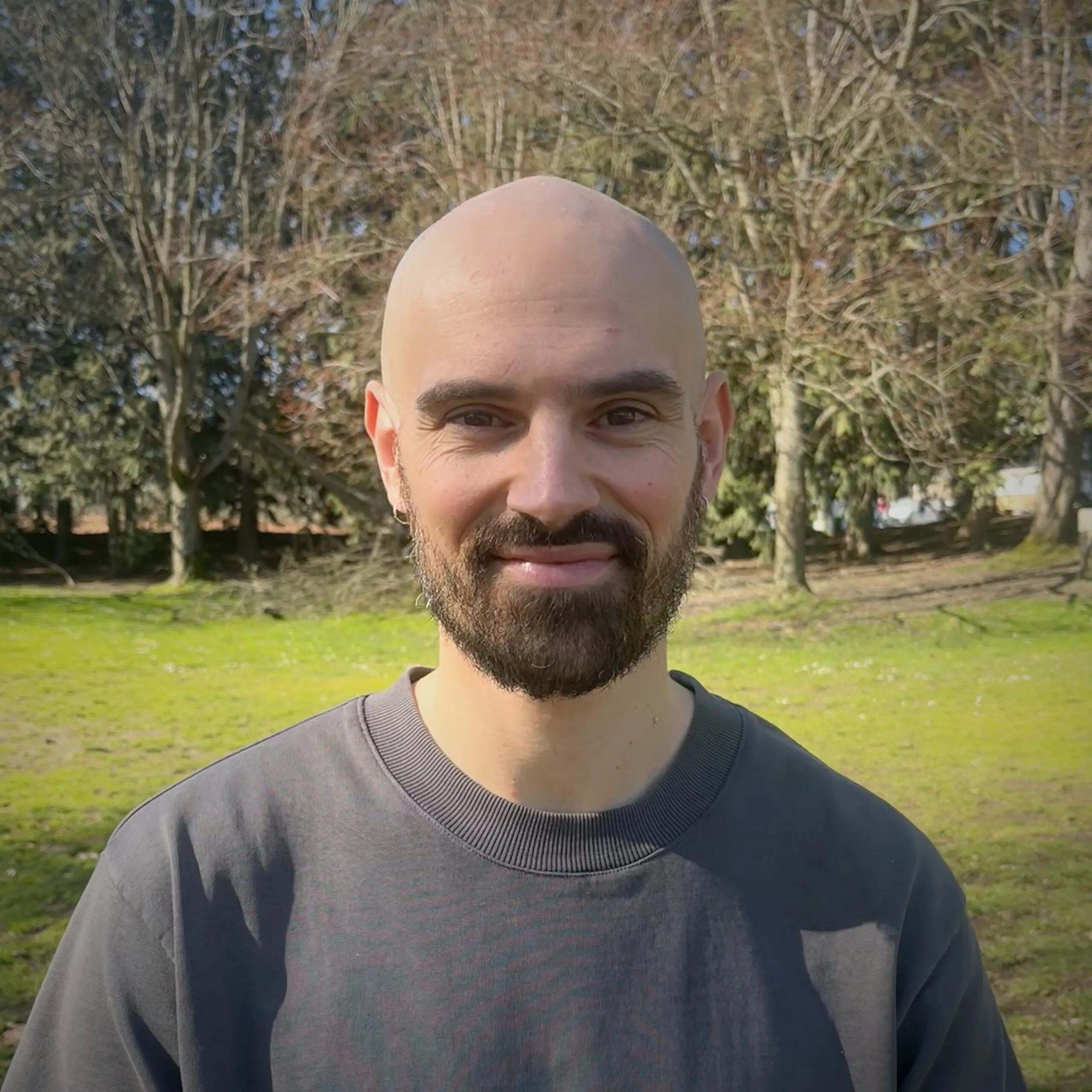 Ben Purinton, smiling, outdoors in a park